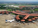 Aerial view of Soekarno-Hatta International Airport, Jakarta (edited horizon). The view taken in 2 January 2010 from Garuda Indonesia airplane during take-off. The architecture reflect Indonesian vernacular architecture of Javanese Joglo roof  with Pendopo as gate lounges (waiting hall) surrounded with tropical gardens.