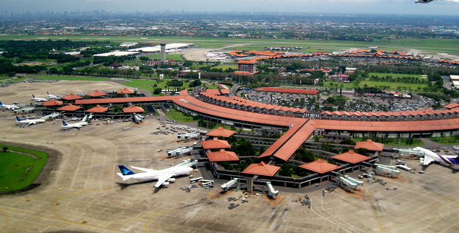 Aerial view of Soekarno-Hatta International Airport, Jakarta (edited horizon). The view taken in 2 January 2010 from Garuda Indonesia airplane during take-off. The architecture reflect Indonesian vernacular architecture of Javanese Joglo roof  with Pendopo as gate lounges (waiting hall) surrounded with tropical gardens.
